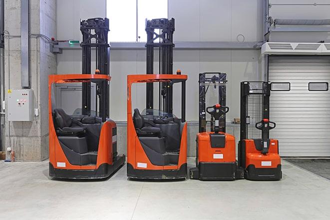 forklifts maneuvering heavy machinery